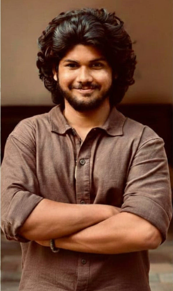 Man with crossed arms on a beige background with text about Shaik Hasif and Dream Oil.